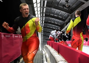 Germany’s Francesco Friedrich (L) and Thorsten Margis (R) celebrate in front of Canada’s team of Justin Kripps and Alexander Kopacz (back) after both teams won the gold medal in the 2-man bobsleigh