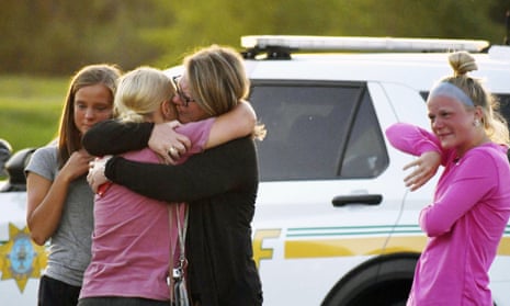 People console each other after a shooting at Cornerstone Church in Ames Iowa on Thursday.