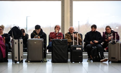 Passengers wait at Gatwick airport on Friday. a