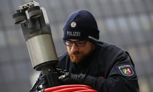 Police officer setting up a surveillance camera in Cologne