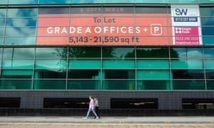 People walk past empty office space in Leeds city centre