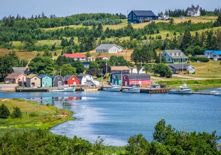 A river inlet with colourful houses and a wharf.