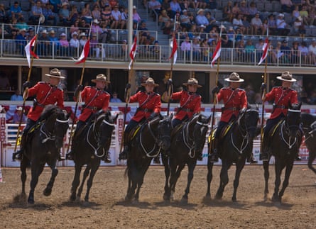Royal Canadian Mounted Police perform to music while riding horses