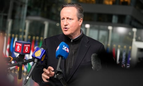 British Foreign Secretary David Cameron speaks with the media as he arrives for a meeting of NATO foreign ministers at NATO headquarters in Brussels.