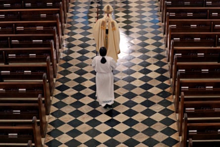 Archbishop Gregory Aymond conducts a procession to lead an Easter mass in St Louis cathedral in New Orleans, in April 2020.