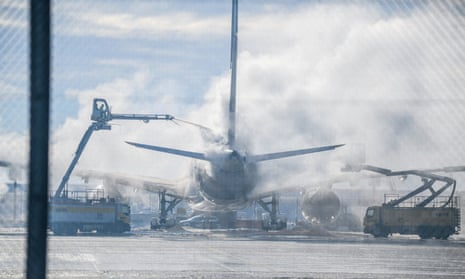 A passenger plane is cleared of ice in Munich Airport, Germany, Tuesday Dec. 5, 2023. After an interruption of several hours due to the weather conditions, Munich Airport has resumed operations.
