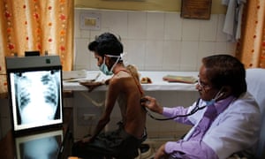 A doctor examines a tuberculosis patient in a government TB hospital in Allahabad, India.