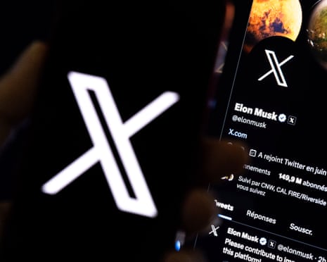 A person holding a mobile phone displaying the 'X' logo in front of Elon Musk's page on X