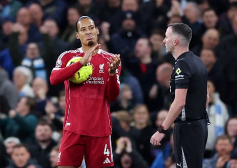 Virgil van Dijk sarcastically claps referee Chris Kavanagh.