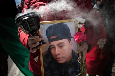Protester holding a photograph of murdered food delivery driver Francisco Villalva Vitinio.