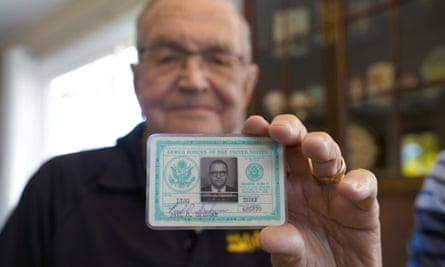 Paul Grisham holds his Navy ID card.