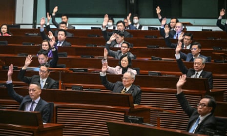 Lawmakers vote for article 23 in the chamber of the Legislative Council after the conclusion of the readings of the Article 23 National Security Law.