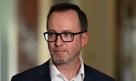 Headshot of man (David Shoebridge) wearing a dark suit, no tie and black-rimmed glasses