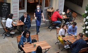 woman serving in a cafe, in a mask