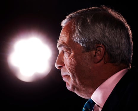 Nigel Farage under a spotlight when on stage at a political event
