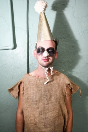 A man in sackcloth, with cone jester's hat, false nose and eyes ringed in black
