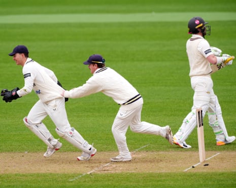 Warwickshire's Kai Smith (left) celebrates after clearing the bails to remove Surrey's Rory Burns.