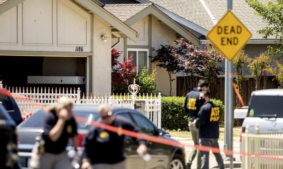 Authorities approach a home being investigated in connection to the shooting.