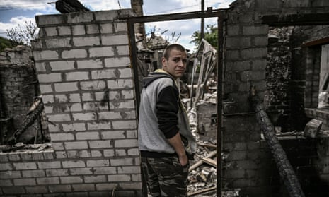 Ivan Sosnin, 19, stands in front of his destroyed house in the city of Lysychansk at the eastern Ukrainian region of Donbas on June 7, 2022.