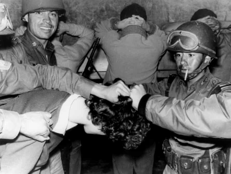 Soldiers cut a student’s hair after he was arrested during the shooting at Tlatelolco.
