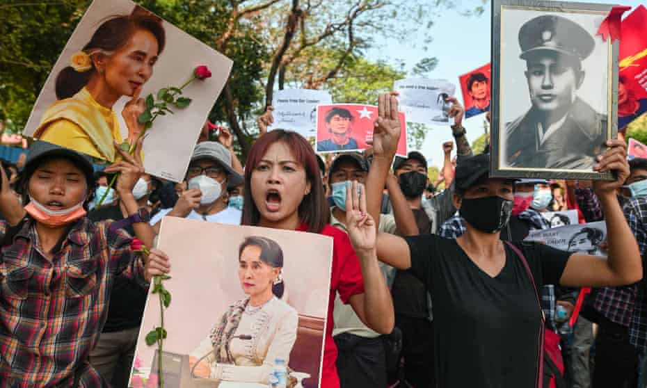 People show the three-finger salute as they rally in a protest against the military coup and to demand the release of elected leader Aung San Suu Kyi, in Yangon, Myanmar
