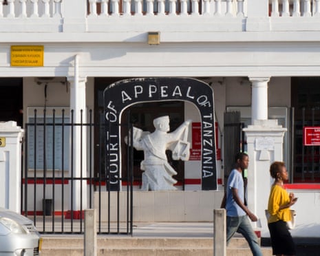 Pedestrians walking past the Court of Appeal building in Dar es Salaam, Tanzania
