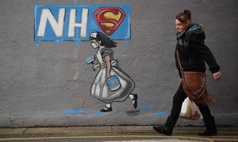 Graffiti depicting the badge of the Superman and Superwoman, and an NHS logo above street art of a nurse, on a wall in Pontefract, West Yorkshire