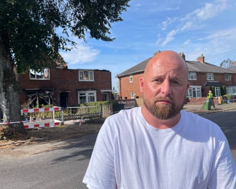 Andrew Reynolds, 42, standing in front of his mother's house which was damaged by a fire in Gorleston Road, Highers Heath, in the West Midlands.