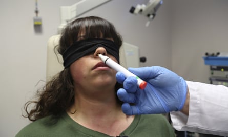 Dr Clair Vandersteen wafts a tube of odors under the nose of a blindfolded patient in a hospital in Nice, France, to better understand COVID-19-related anosmia.
