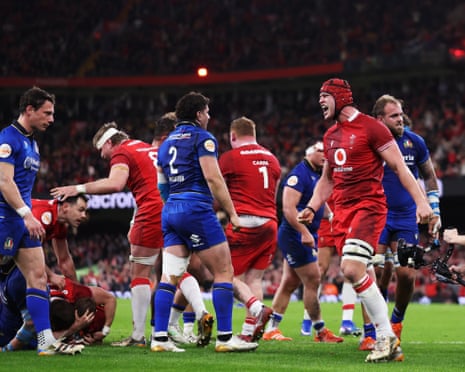 James Botham of Wales celebrates after Dewi Lake of Wales (obscured) scores his team's third try.