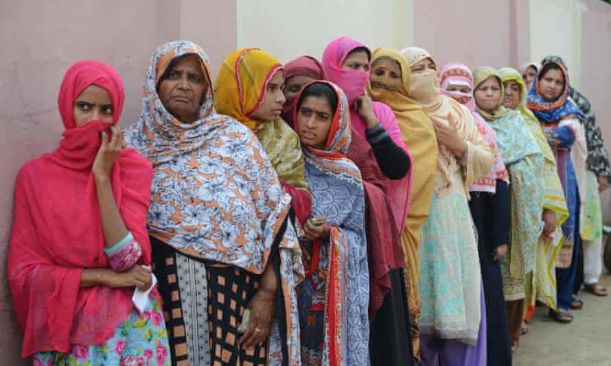 Women queue to cast their vote in Lahore