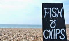 Hand written wooden sign advertising fish and chips on a uk pebble beach.; Shutterstock ID 193342049; purchase_order: -; job: -; client: -; other: -