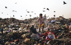 Wastelands of MumbaiA young boy walks over the garbage to collect plastic waste after sunrise. He helps his father every day by working in the dump. There are many kids who work here who can’t afford to go to school.