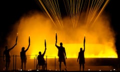 Torchbearers Charles Antoine Kouakou, Fabien Lamirault, Elodie Lorandi, Nantenin Keita and Alexis Hanquinquant gesture after lighting the Cauldron in Paris.