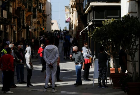 Non-essential shops and services reopen for business after a seven-week-long shutdown in MaltaPeople wearing protective face masks queue to enter a shopping arcade as non-essential shops and services reopen for business after a seven-week-long shutdown because of the pandemic in Valletta, Malta on 26 April, 2021.