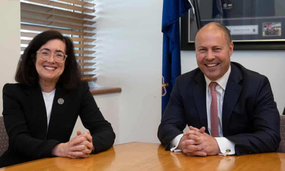 Josh Frydenberg and Gina Cass-Gottlieb sit next to each other at a wooden table in an office