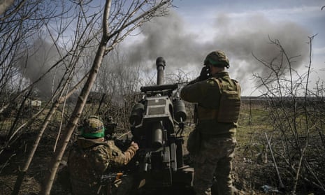 Ukrainian soldiers fire an M119 105mm howtitzer at Russian positions near Bakhmut.