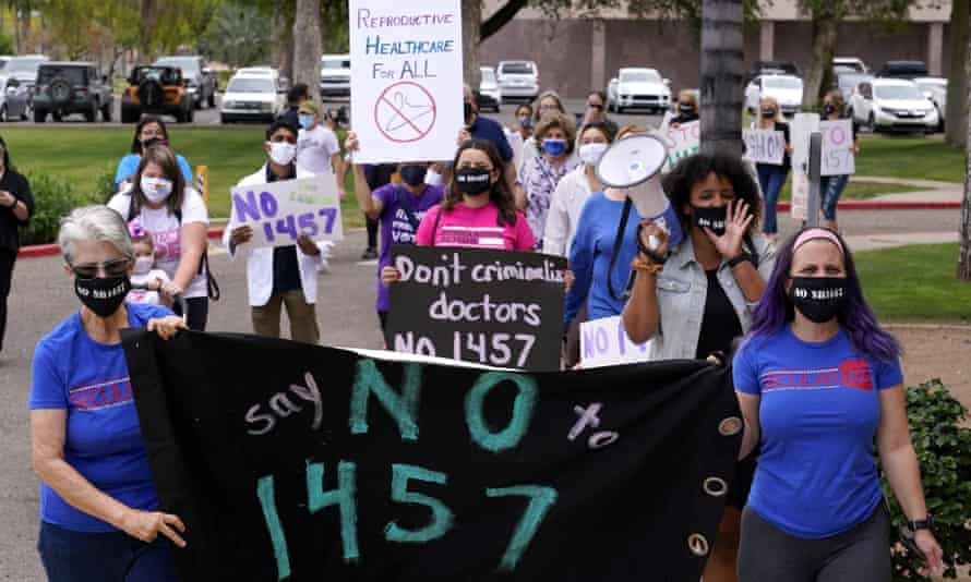 Arizona reproductive rights groups march to deliver a petition to Doug Ducey to veto the latest abortion bill passed by the state legislature.
