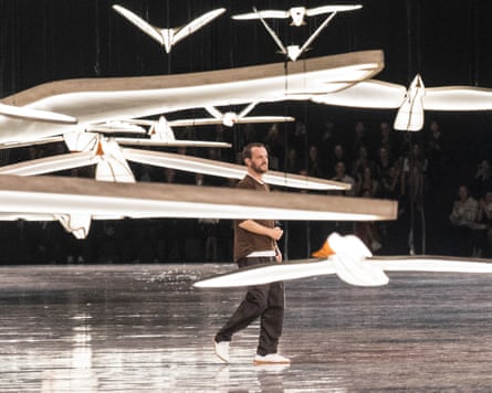 Matthieu Blazy on the runway surrounded by suspended bird decorations