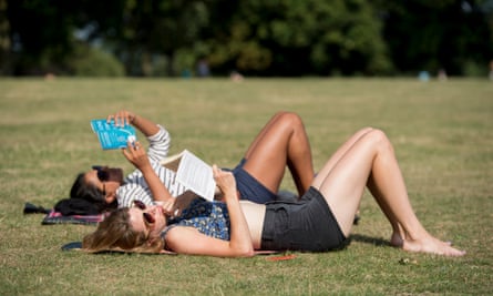 People relax in the sun in Finsbury Park.