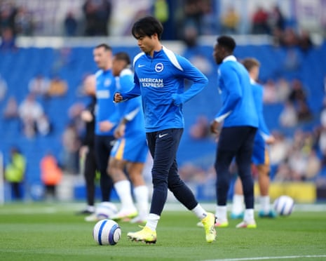 Kaoru Mitoma warms up at the Amex, but the Japanese is only on the Brighton bench against Liverpool.