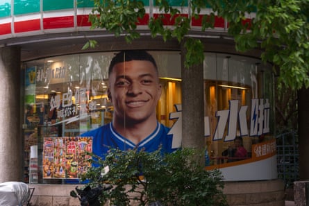 An advertisement for a drink brand, featuring Kylian Mbappé, in Shanghai.