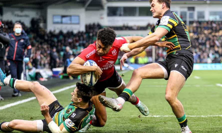 Ulster's Robert Baloucoune scores his team's first try despite the best efforts of Tom Collins and George Furbank.