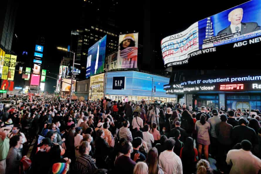 In Times Square, New York, people gather to watch president-elect Joe Biden give his victory speech.