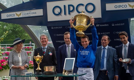 William Buick holds the King George Trophy after victory with Adayar