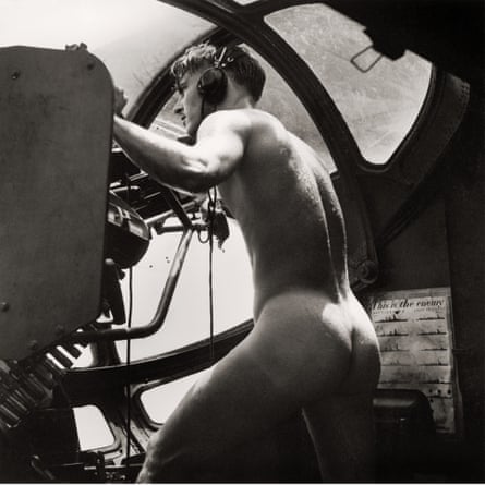 Photgraph of a man in a wartime plane with no clothes on, only headphones