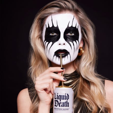 Advertising image showing a young woman with scary black and white face paint drinking Liquid Death from a straw