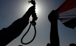 An Egyptian anti-Mubarak protester holds a noose during a protest in Cairo