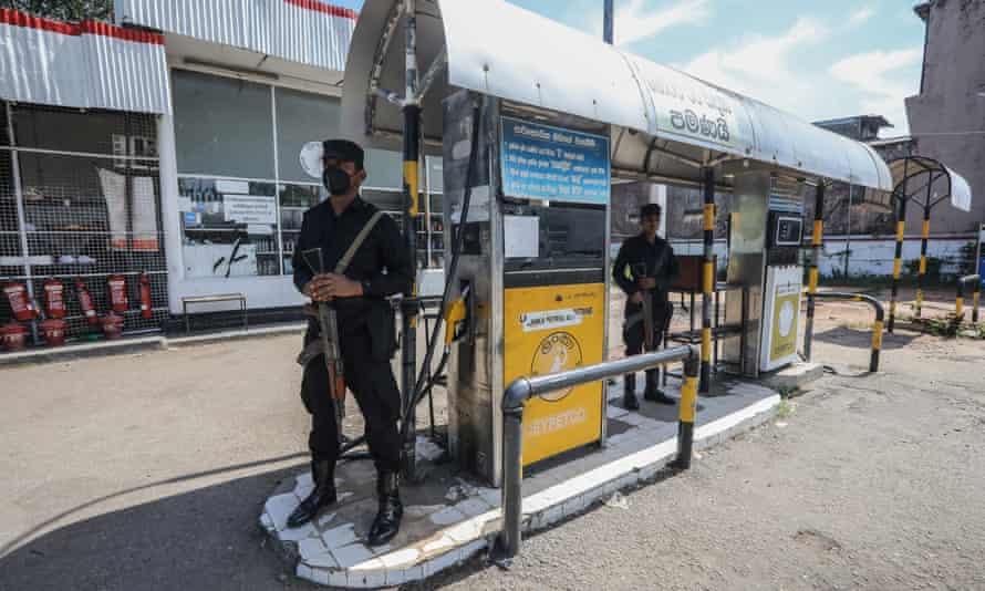 Armed Sri Lankan military personnel stand guard at a closed gas station this week