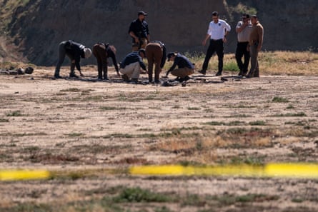 Mexican authorities searching a site where the three tourists camped before their bodies were found in a well.